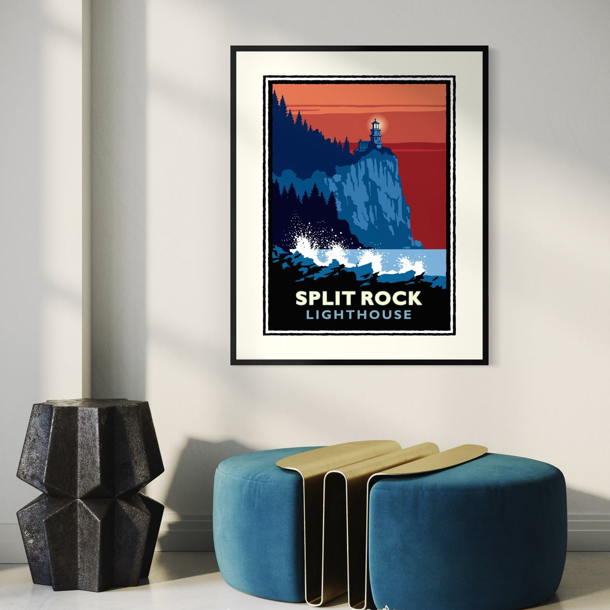 a framed poster of the Split Rock Lighthouse, which is hanging on a wall in a room.