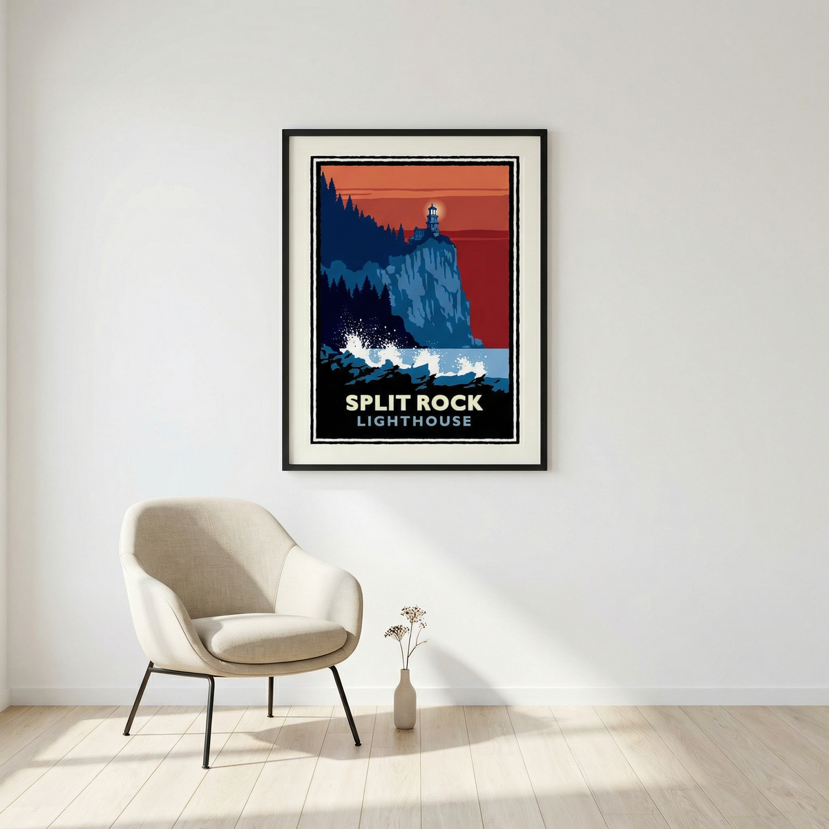 a framed poster of the Split Rock Lighthouse hanging on a white wall, with a beige armchair positioned in front of it.