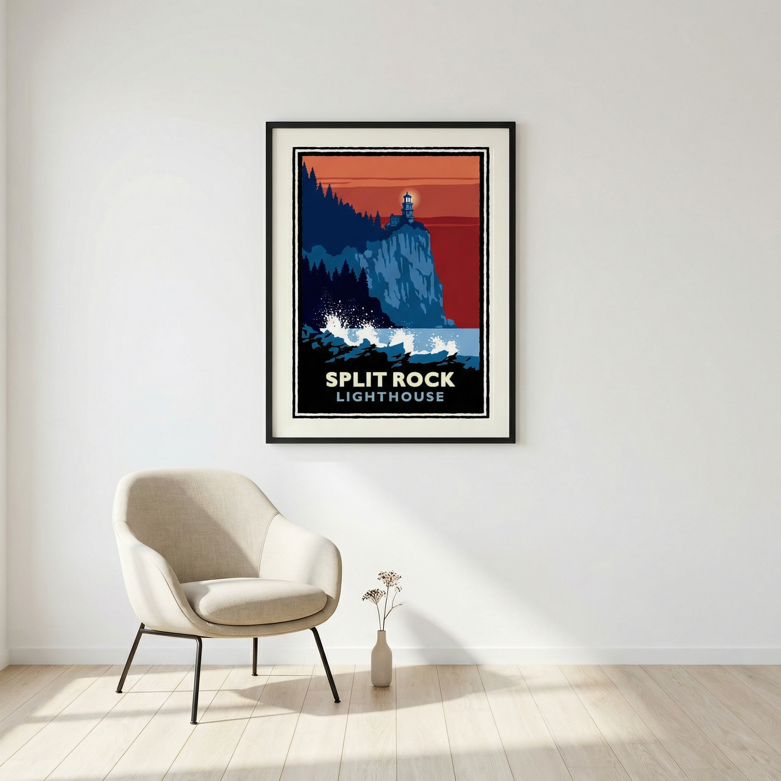 a framed poster of the Split Rock Lighthouse hanging on a white wall, with a beige armchair positioned in front of it.